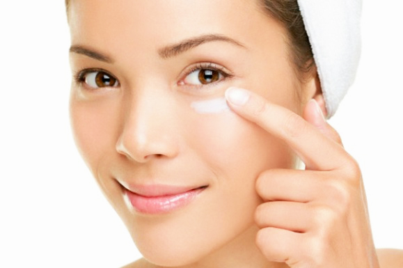 Woman Putting On Eye Cream