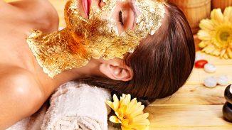 a woman using gold body butter