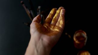 gold butter on a woman's hand