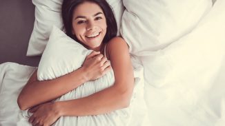 woman hugging a pillow